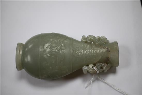 A Chinese celadon jade archaistic flattened pear shape vase, Qianlong / Jiaqing period, 10.9cm